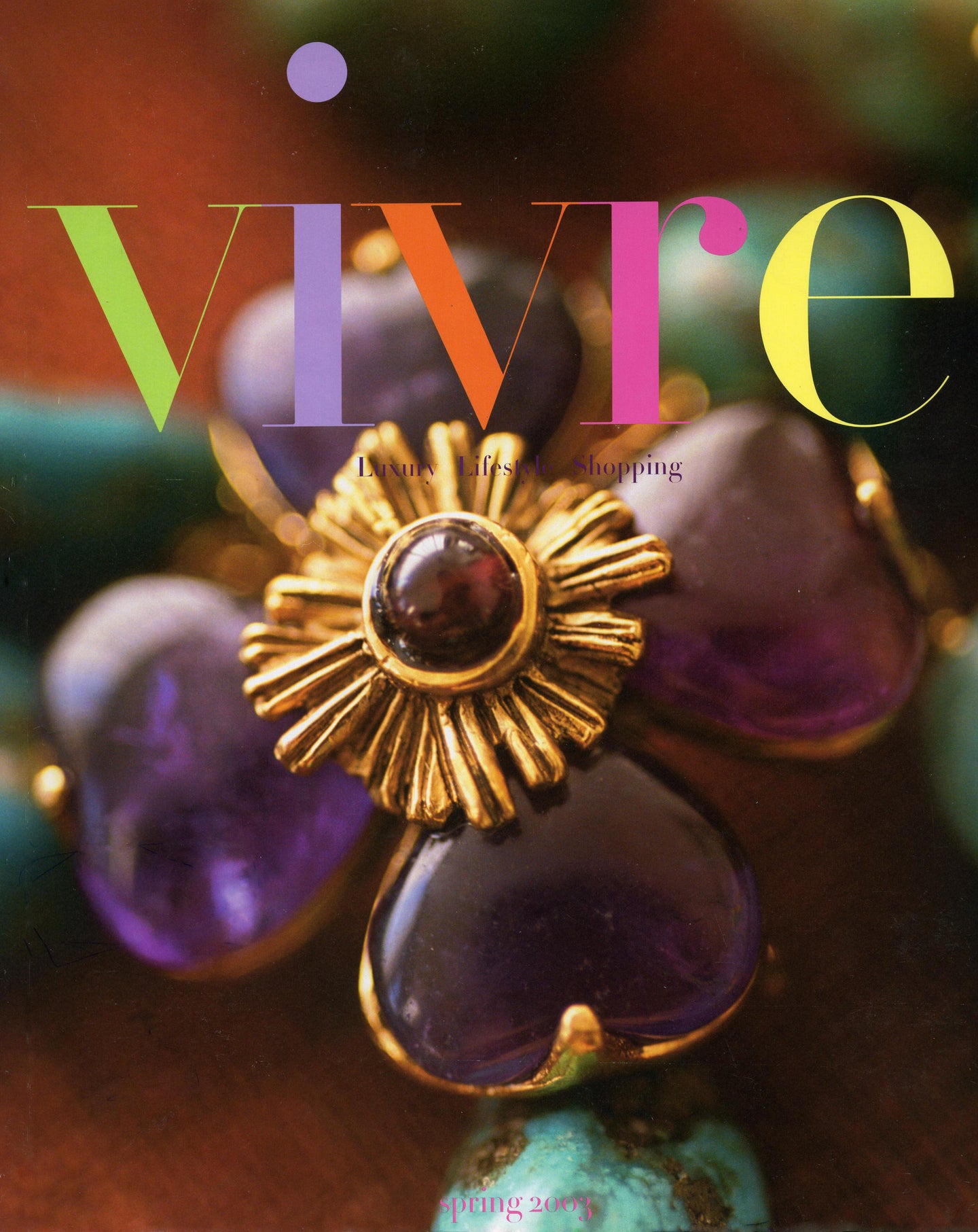 Jewelry with a 'Vivre' magazine cover design featuring colorful text.