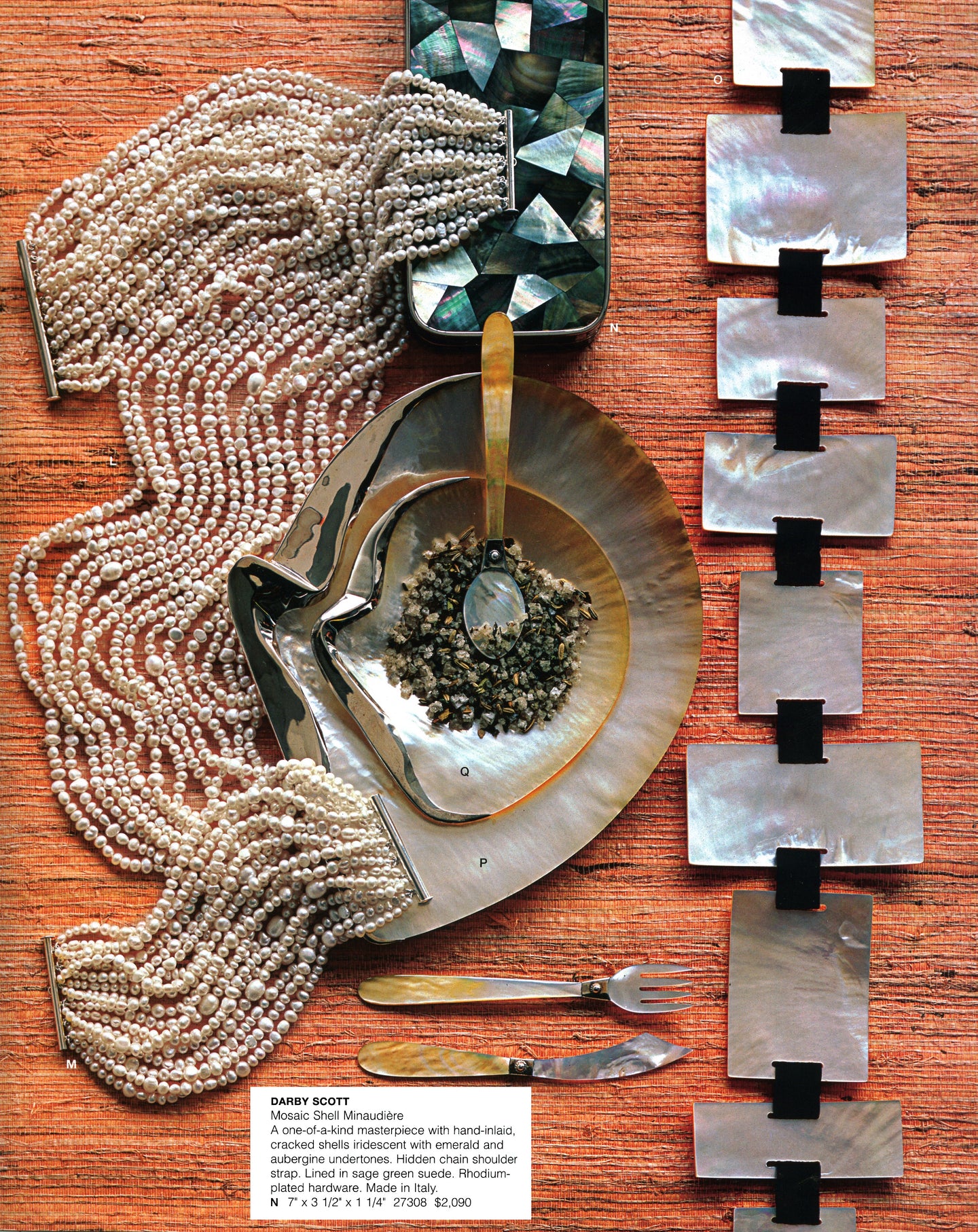 Mother-of-Pearl Clutch by Darby Scott & Jewelry set with pearls, gemstones, and metal pieces on a wooden surface
