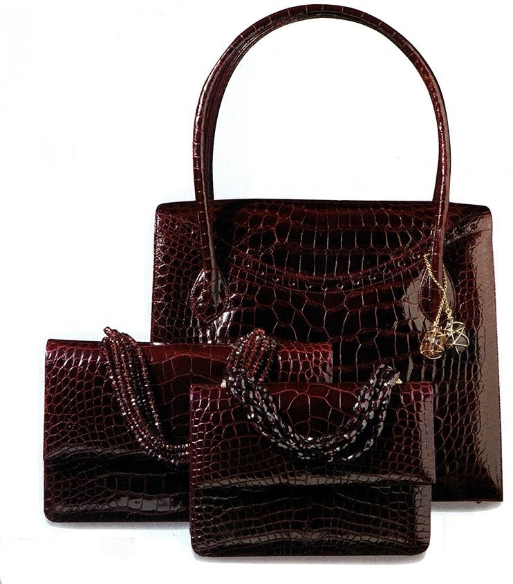 A collection of Red Alligator Handbags with Jeweled Handles and accents by Darby Scott