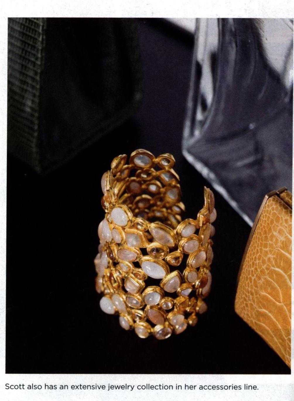 A gold cuff bracelet with bezel set moonstones- Darby Scott