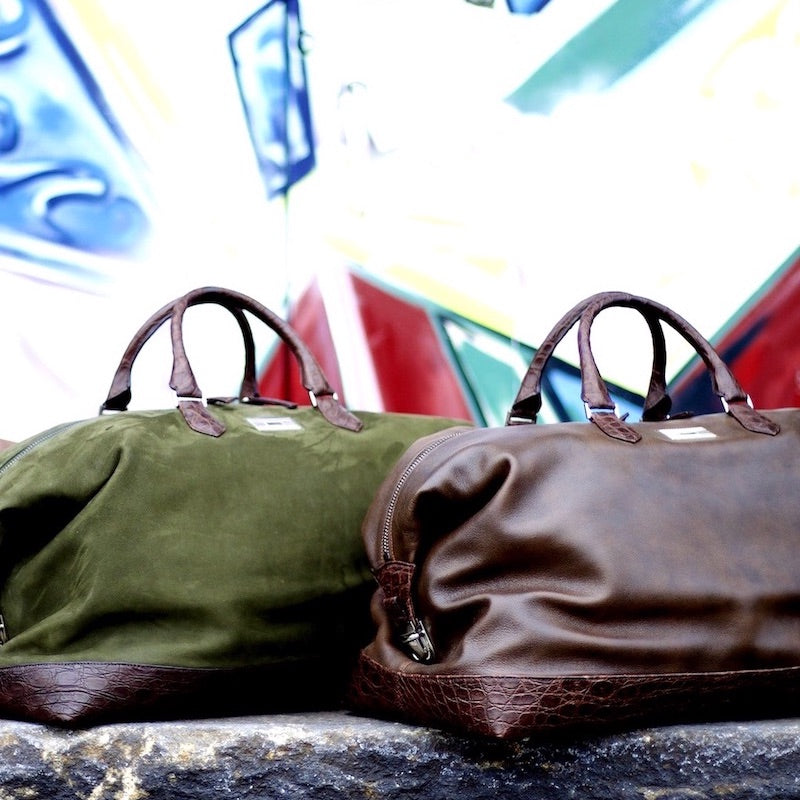 Aspen travel bags in front of Graffiti painted doors