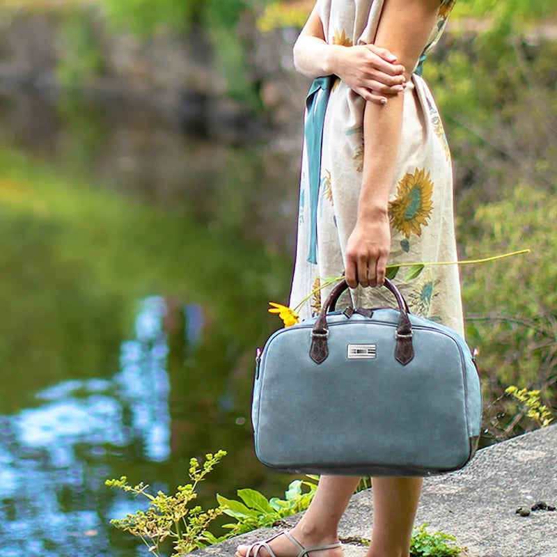 Blue Suede Newport Monogram Carry-On Bag held by woman in linen dress - Darby Scott