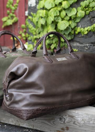 Leather travel duffle bags by Darby Scott