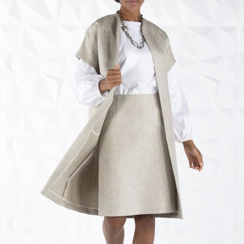 Model in light tan tweed jacket and skirt with white blouse  - Darby Scott