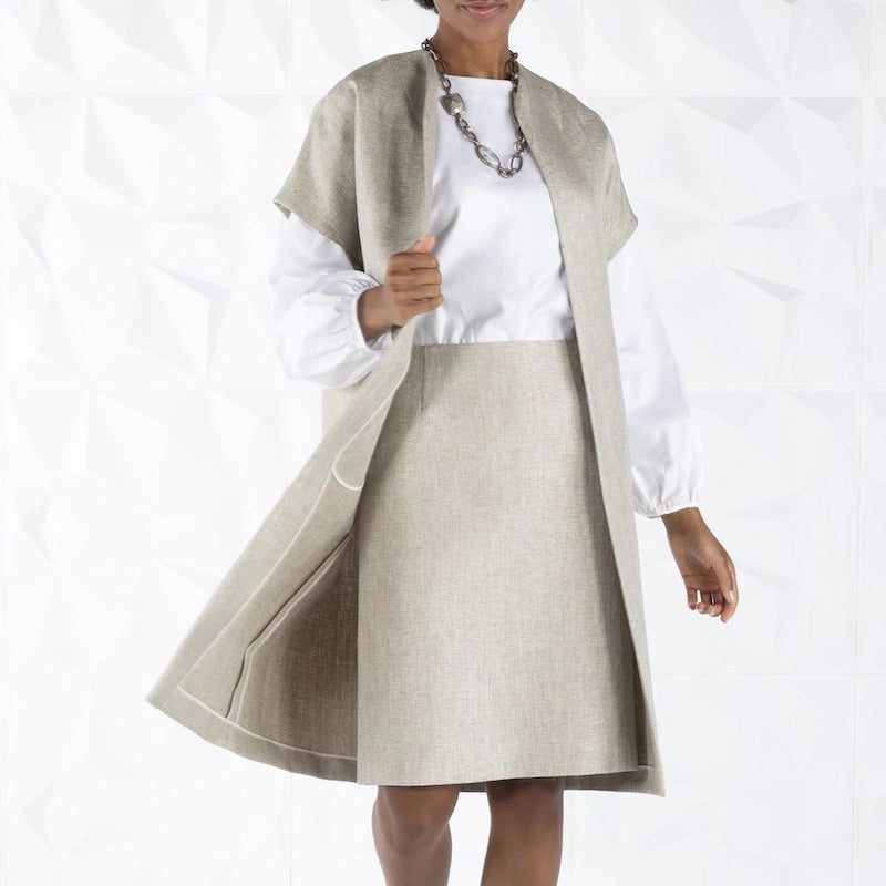 Model in light tan tweed jacket and skirt with white blouse - Darby Scott
