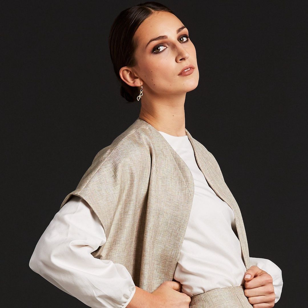 Model in light tan tweed jacket and skirt with white blouse - Darby Scott