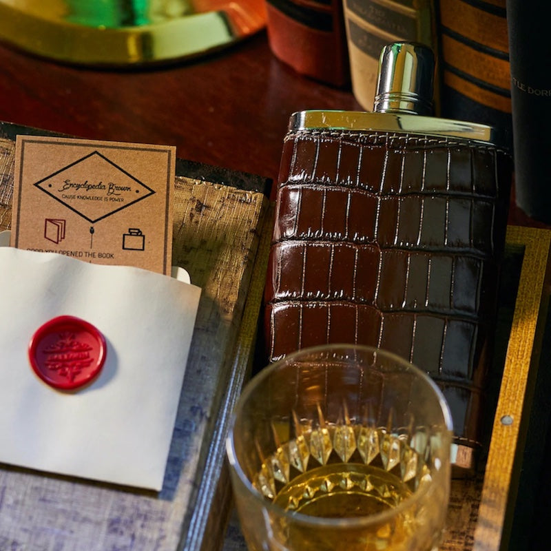 Croc covered flask and glass with beverageby designer Darby Scott