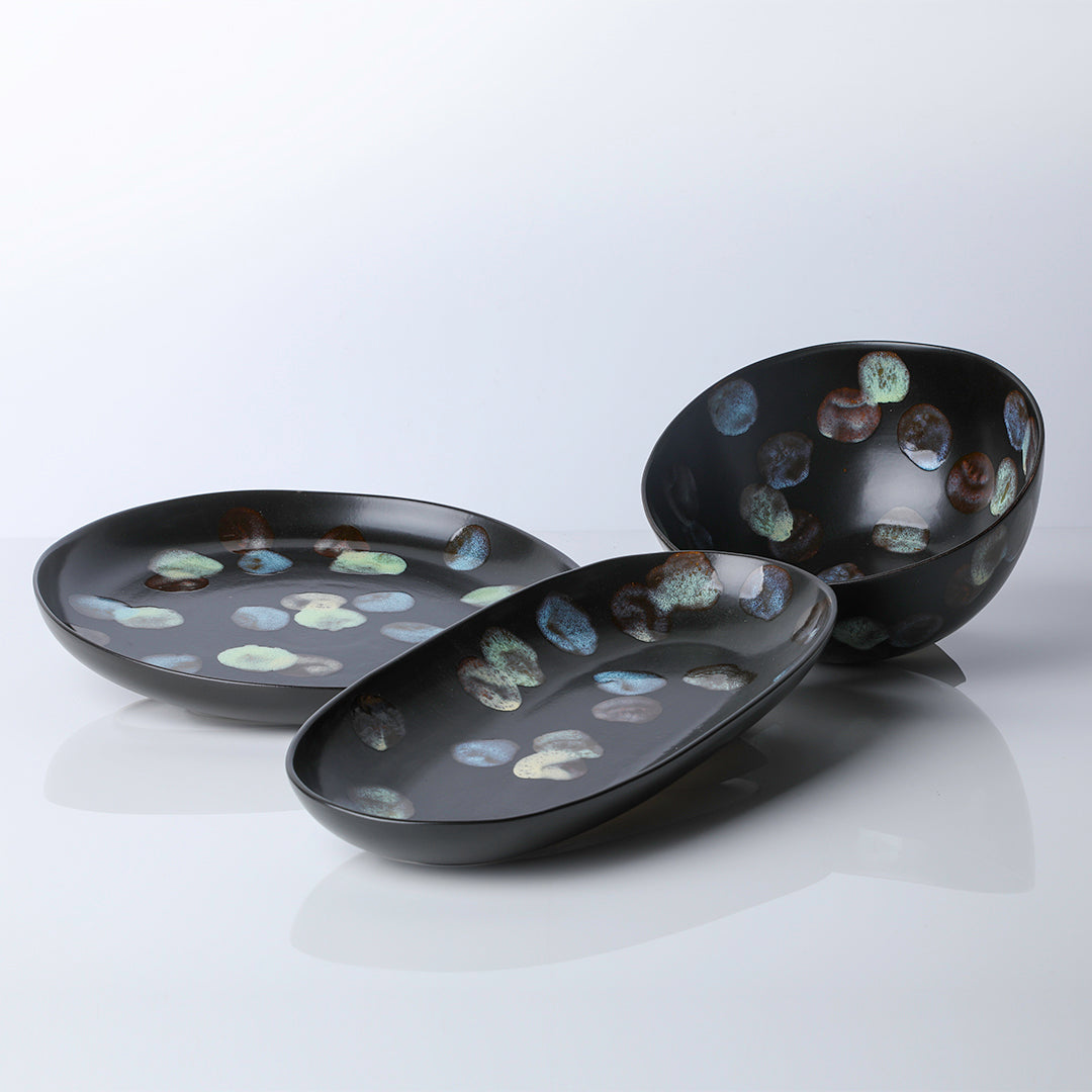 Ceramic serve ware in ebony with dappled colored dots