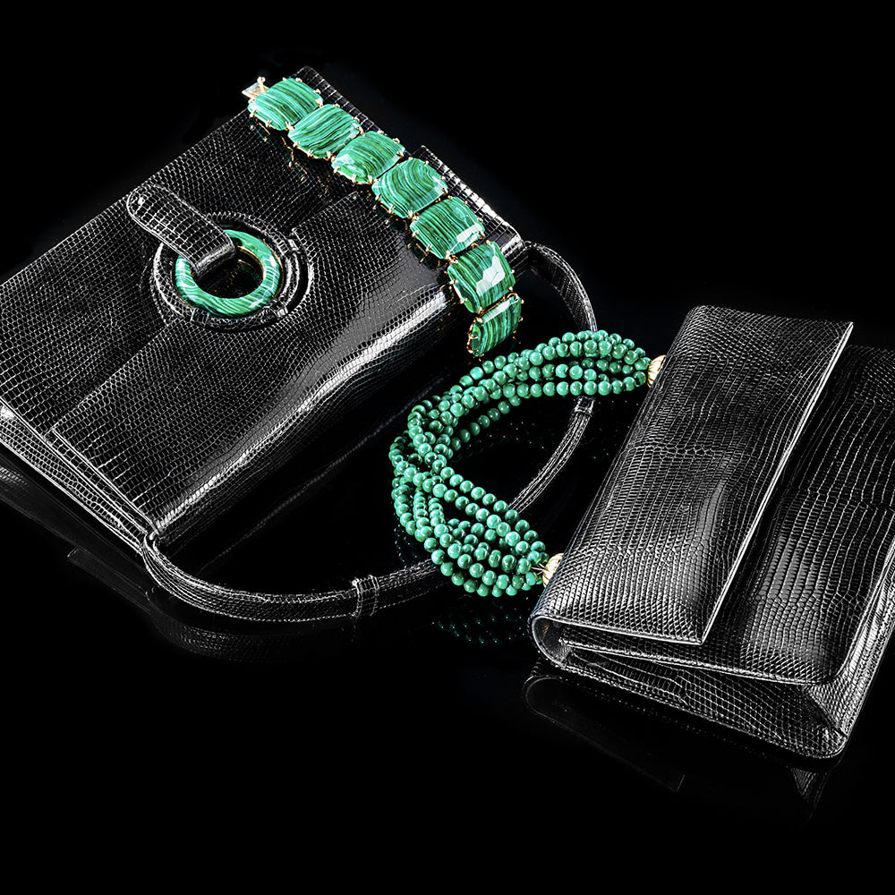 two black lizard handbags and a bracelet. One bag with malachite beaded handle, other with malachite grommet closure. Malachite cabochon bracelet.