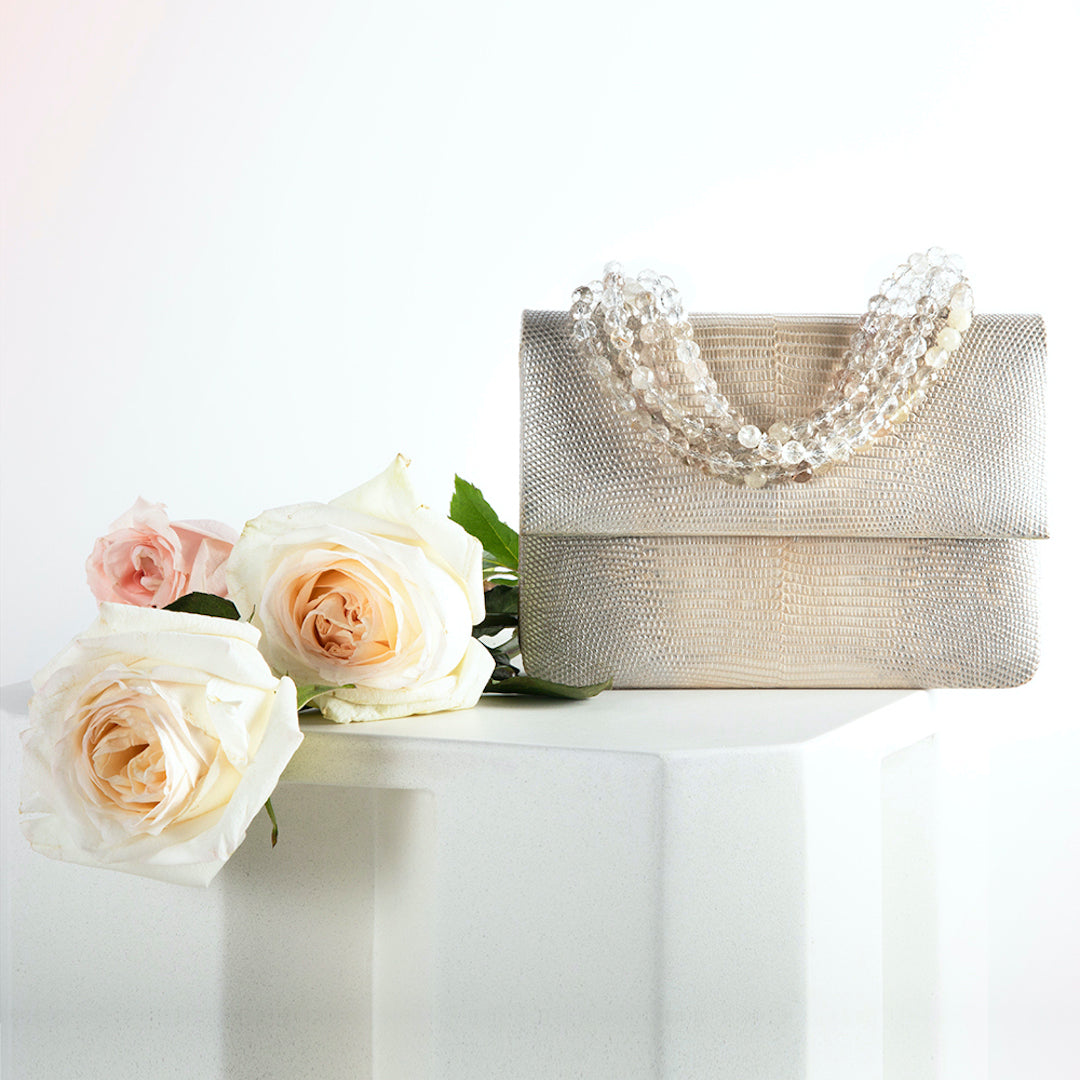 Silver Wash Ring Lizard Handbag with Faceted Quartz Necklace Handle next to roses - Darby Scott