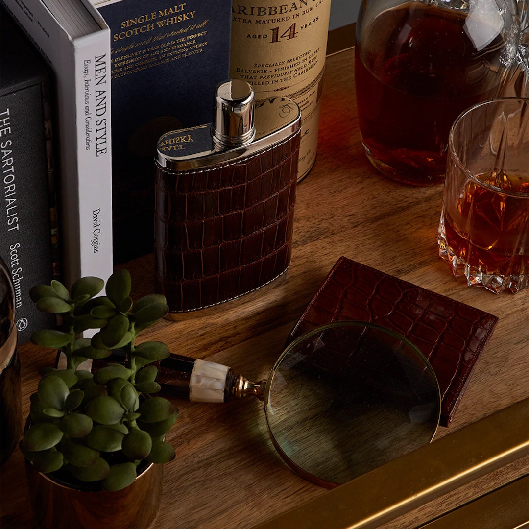 Bar cart with brown crocodile covered flask and wallet