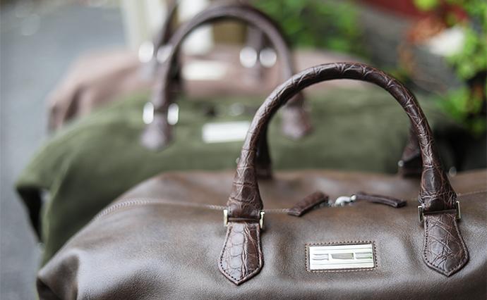 monogram plate and handles of duffel bag