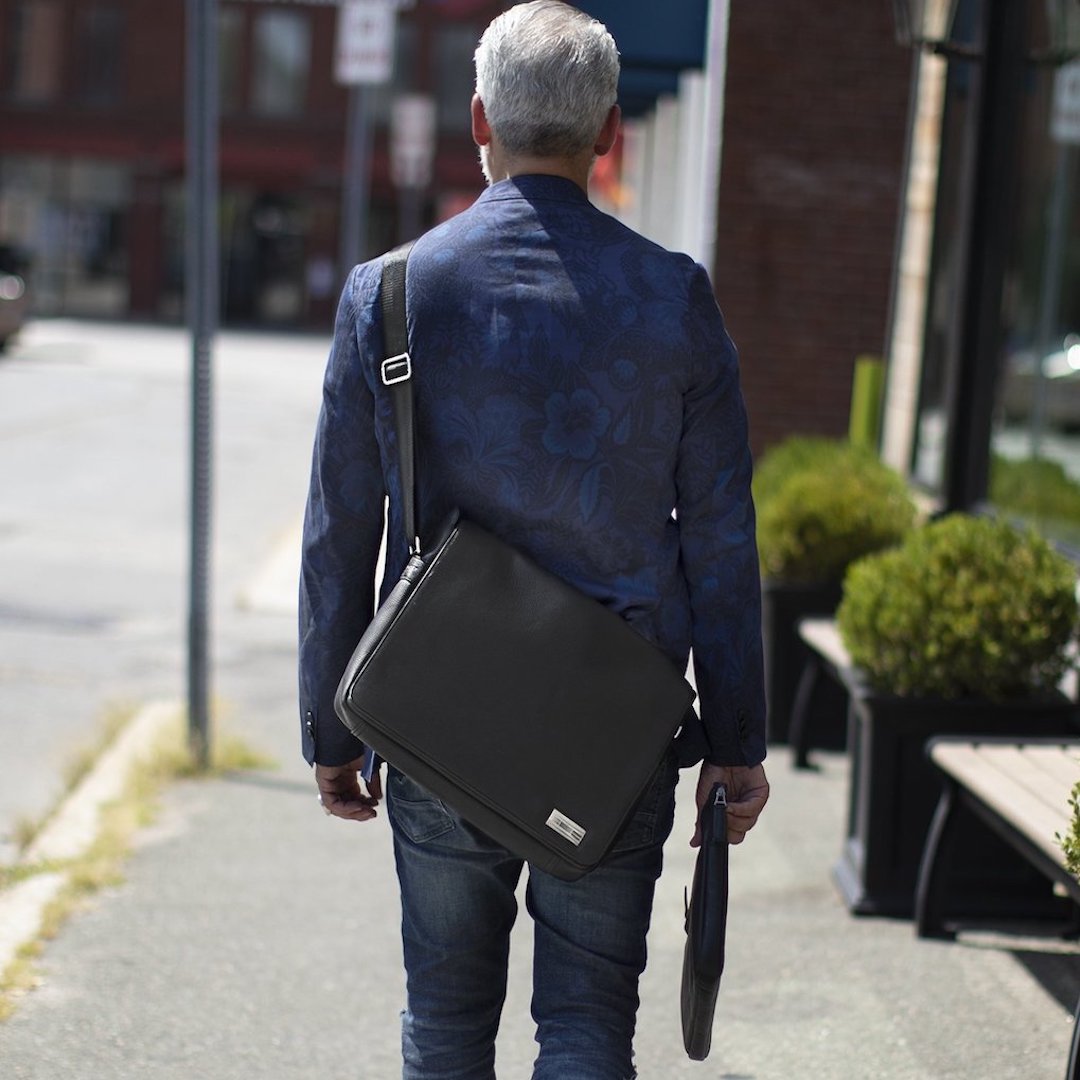 Man carrying a messenger bag and laptop case - Darby Scott