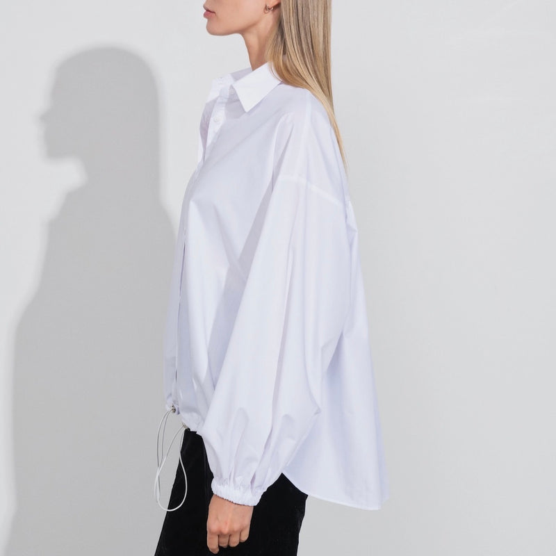 Long sleeve white blouse on model, side view - Darby Scott