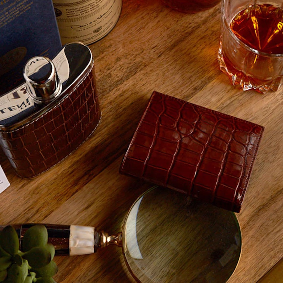 Bar cart with brown crocodile covered flask and wallet 