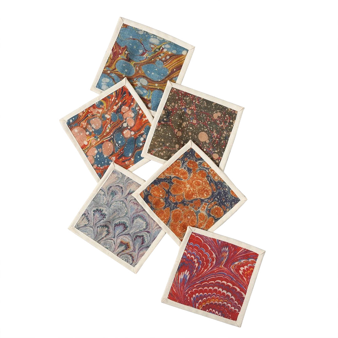 Set of six cocktail napkins, printed patterns on fabric.