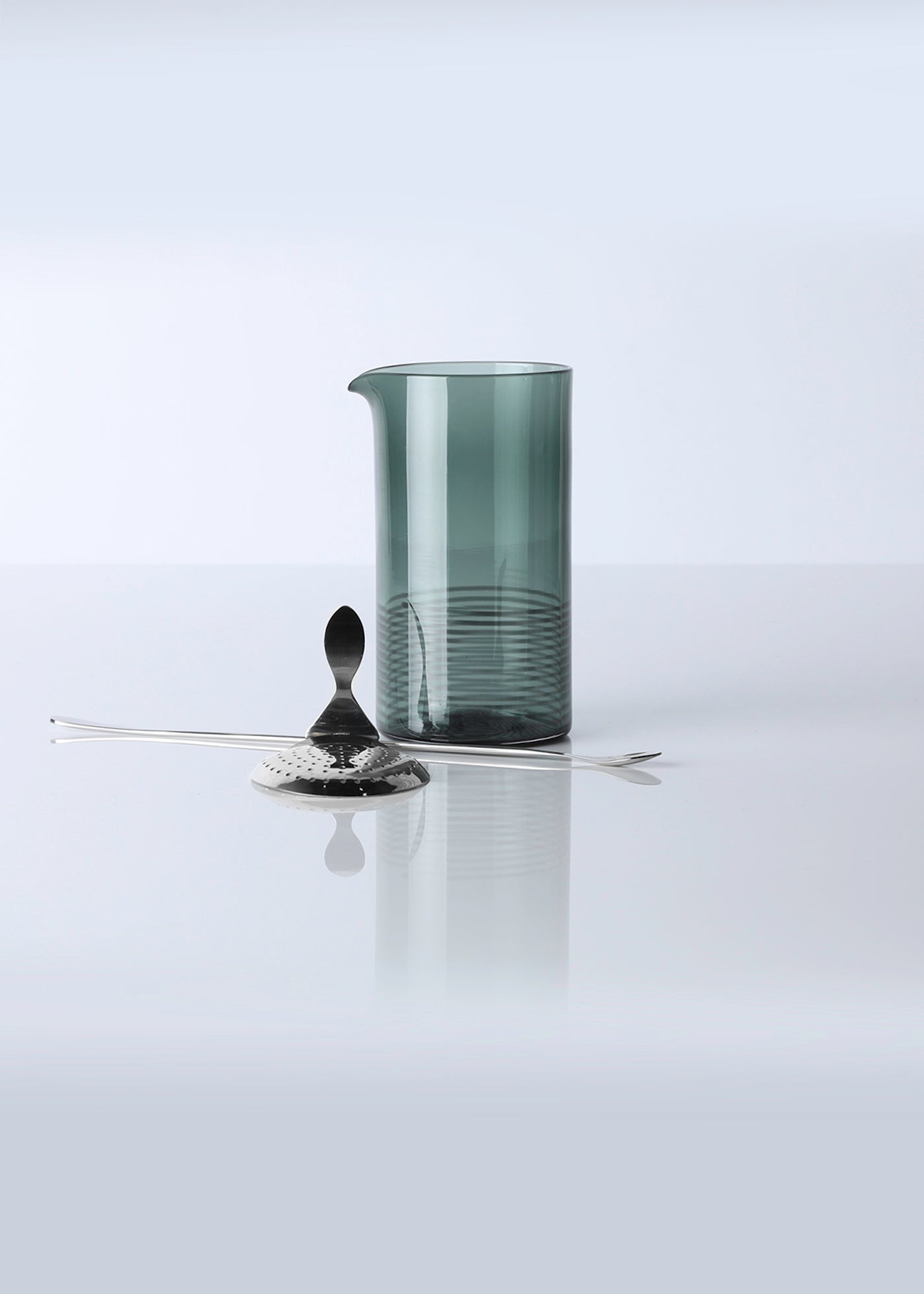 Hand blown dark green mixing glass with long spoon and strainer