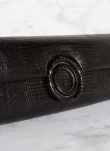 Detail view of Black Onyx Grommet on black lizard clutch - Darby Scott 