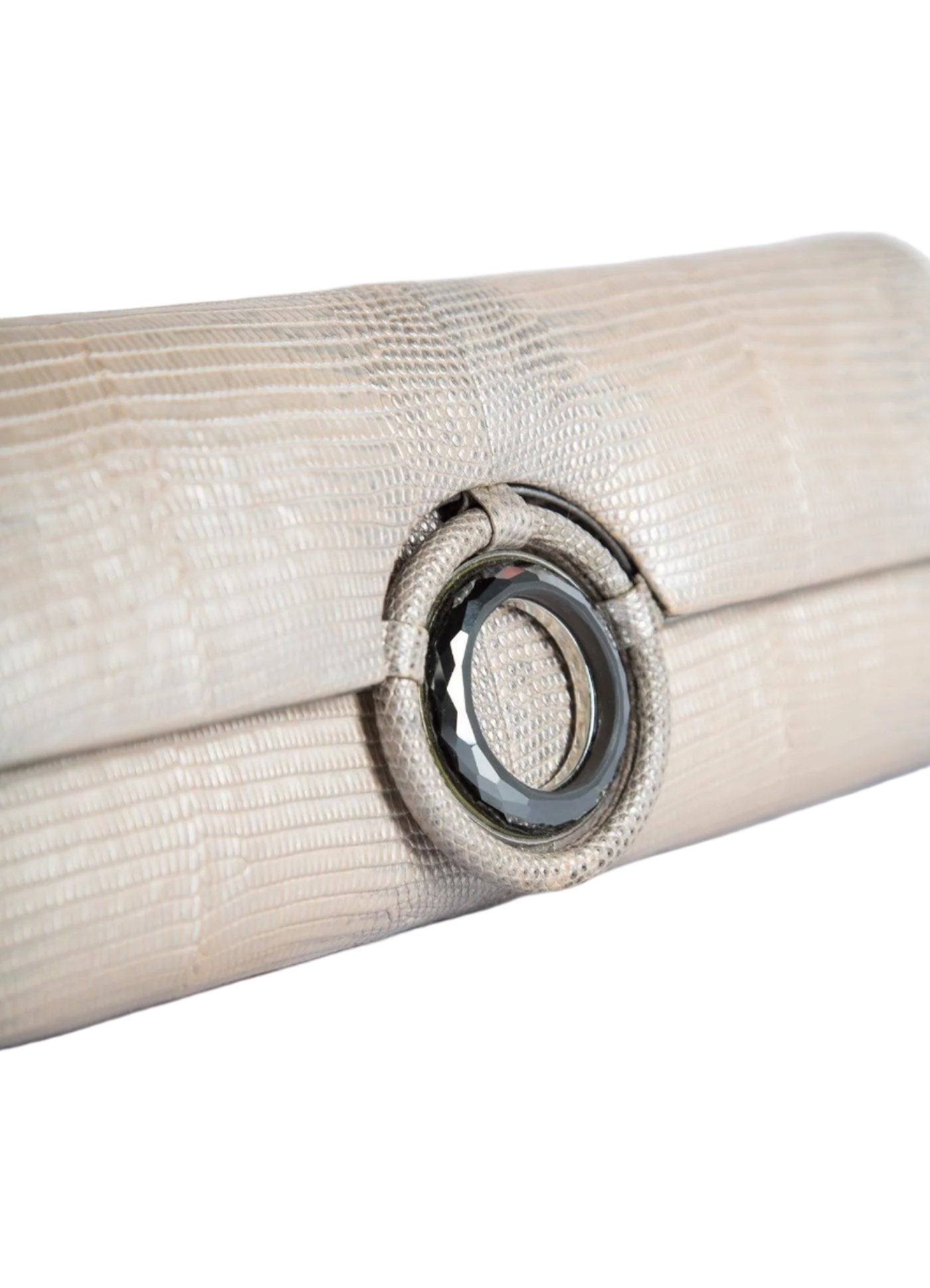 Detail view of Hematite Grommet Inlay on champagne lizard clutch - Darby Scott