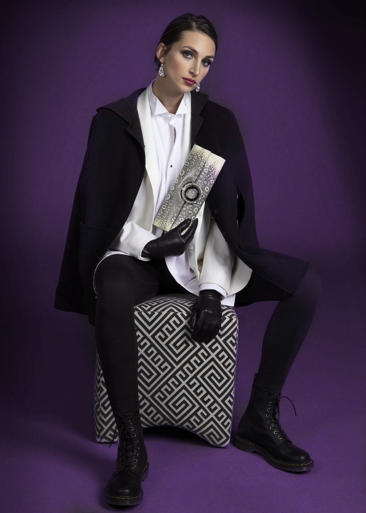 Model with Black & White Ring Lizard Grommet Roll Clutch - Darby Scott