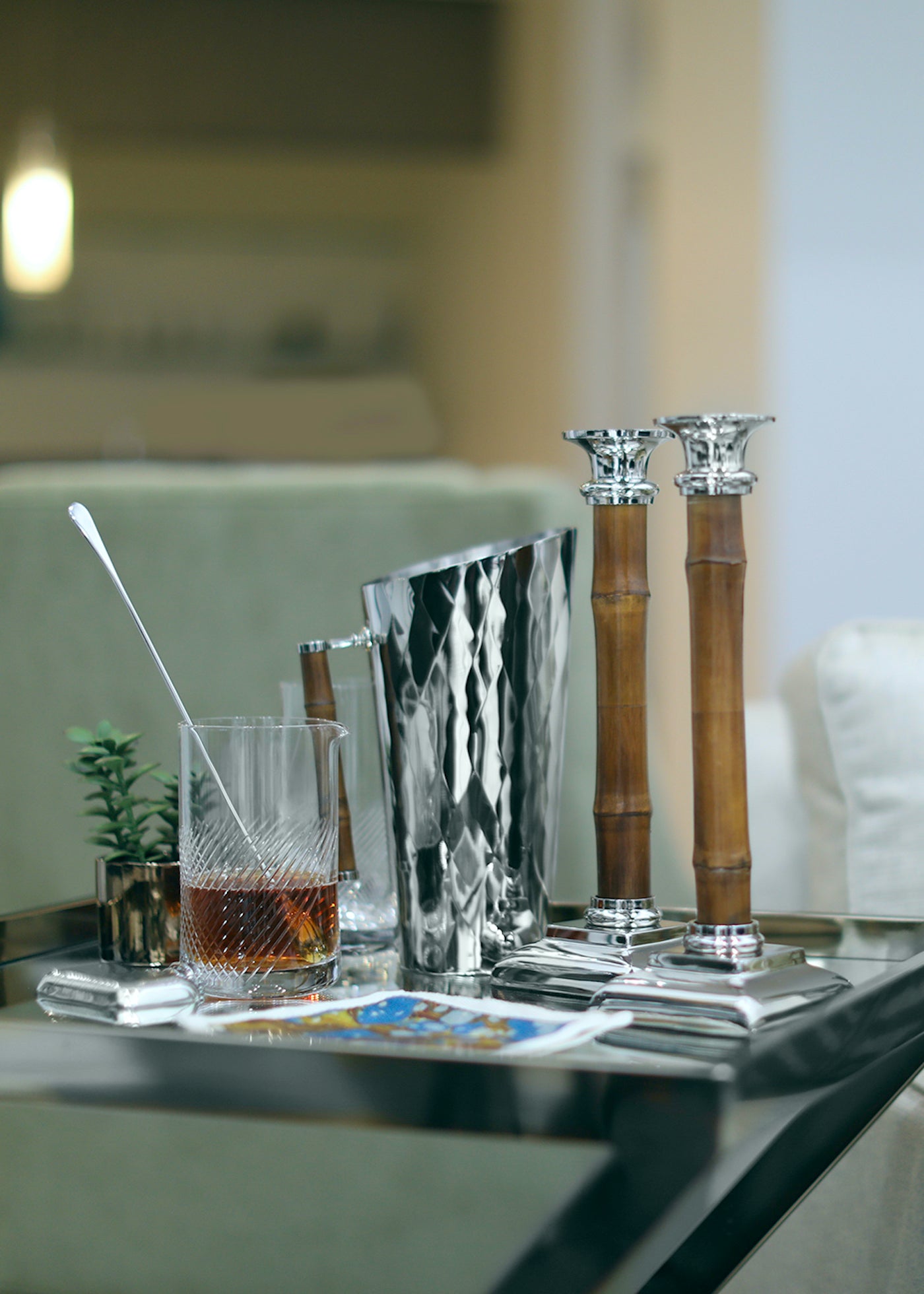 Pitcher, Candlesticks and Mixing Glass with stirrer on bar cart
