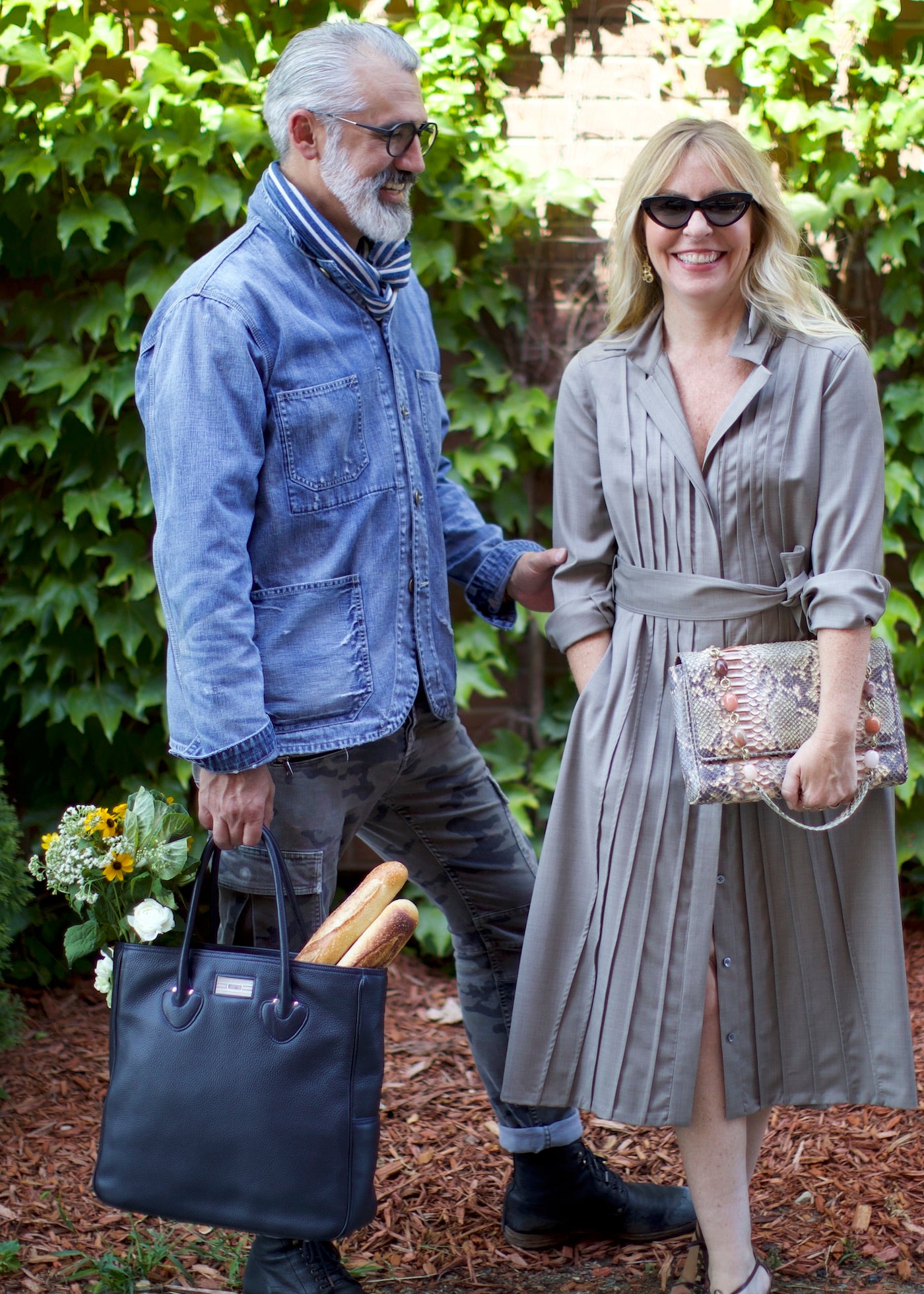 Man in Indigo Striped scarf carrying an Essex Tote, Women in Darby Scott Dress