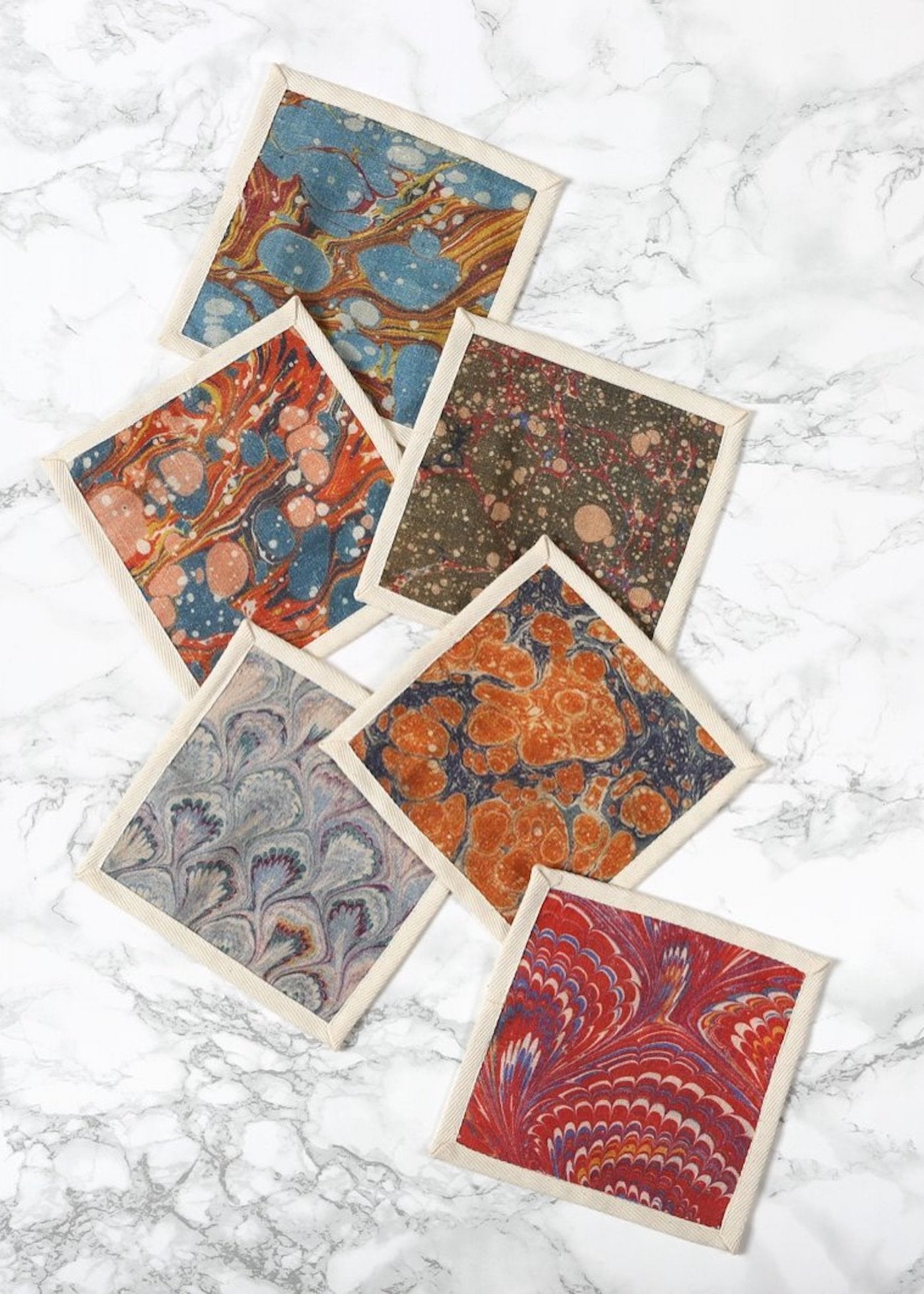 Set of six cocktail napkins, printed patterns on fabric.