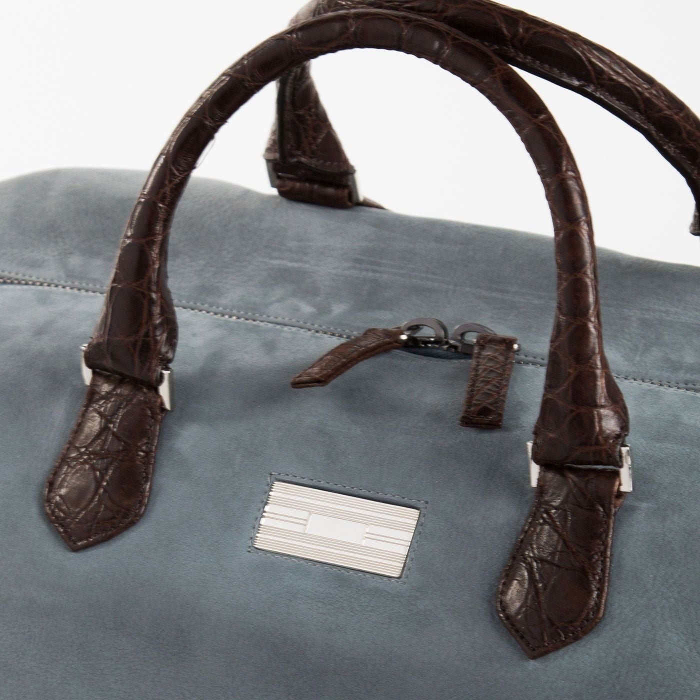 Close Up of Sterling Silver Monogram Plate on Aspen Travel Duffle Bag - Darby Scott