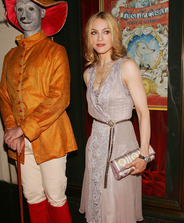 picture of Madonna carrying a Darby Scott embroidered clutch to her children's book launch at Bergdorf Goodman 