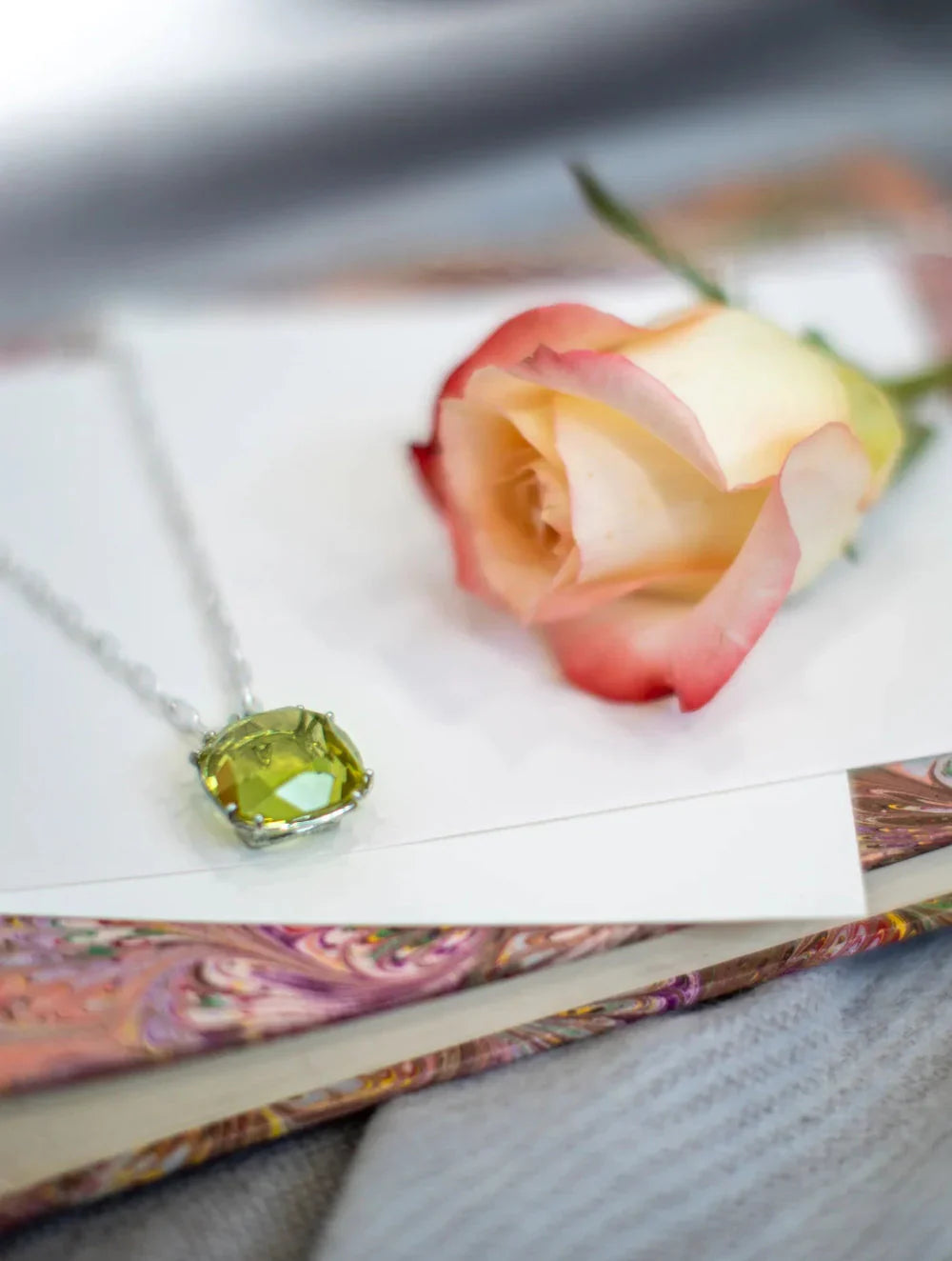 Cushion Cut Gemstone Pendant on Book with Rose - Darby Scott