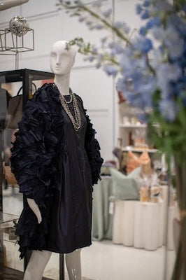 mannequin in wears Darby Scott navy blue taffeta dress and beaded necklace