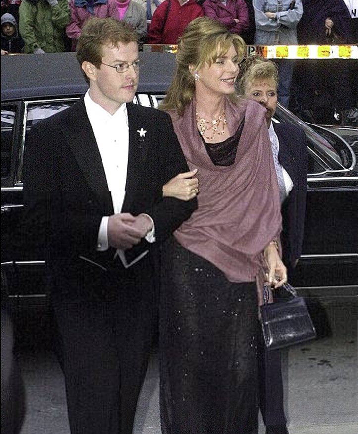 Queen Noor of Jordan carrying Darby Scott handbag