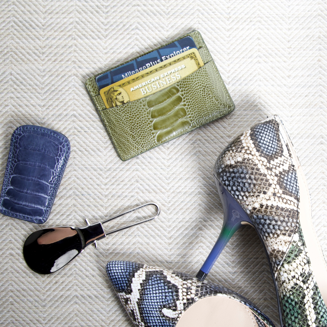 Show Horn, and Credit Card Case by Darby Scott next to a pair of high heals