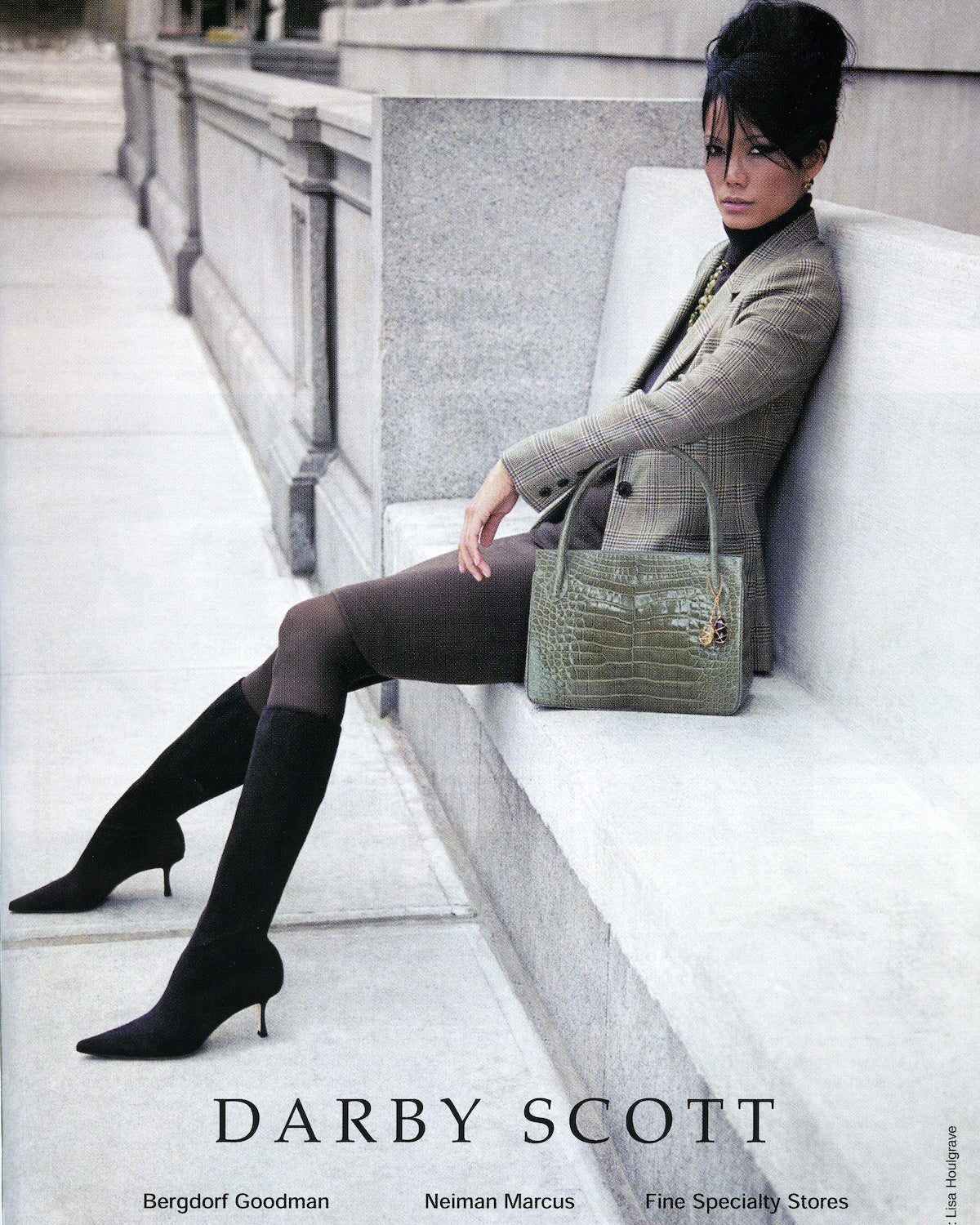 Harpers Baazar Ad showing a model on bench with a Darby Scott Thompson Tote in green Alligator