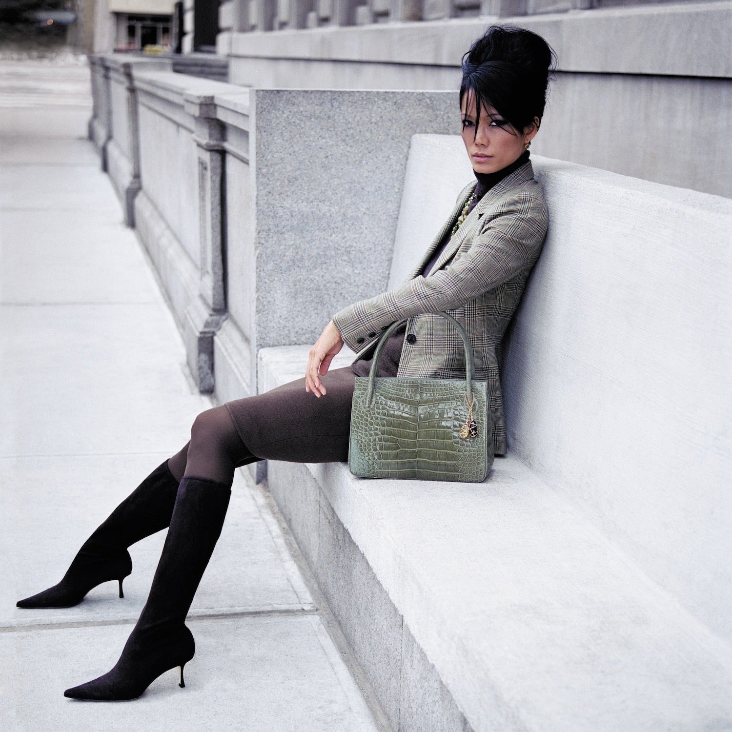 Model sitting on a bench with Darby Scott Blaire open tote in green alligator
