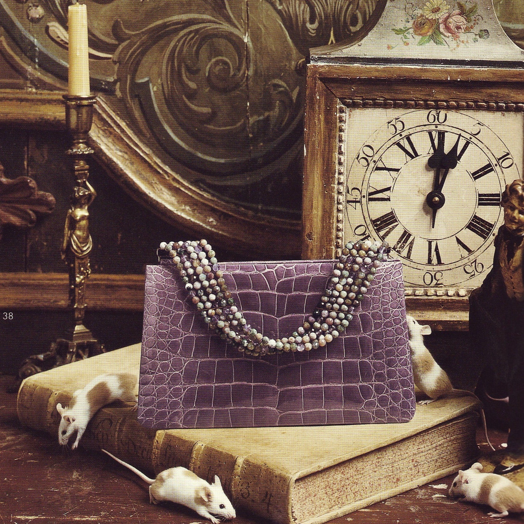 Darby Scott's mauve alligator evening bag with jasper beaded handle is presented in a fairytale setting. 