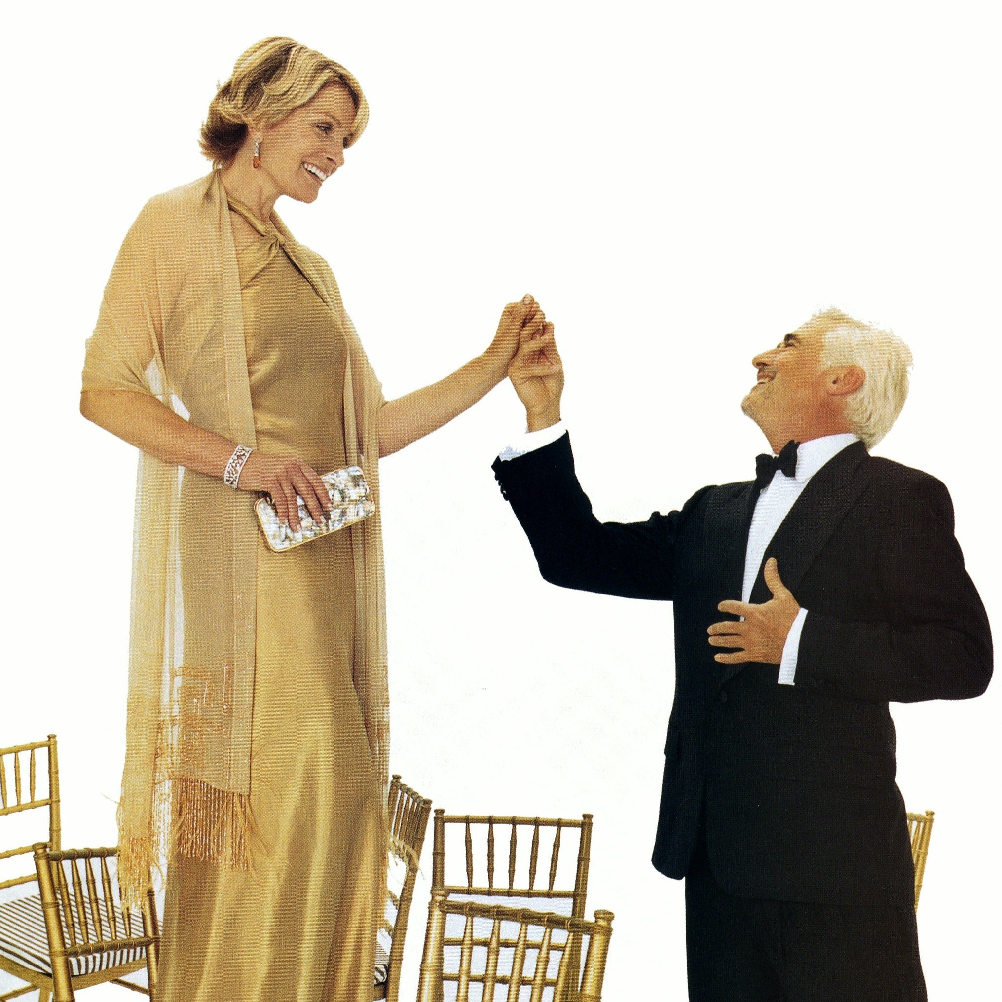 A couple in formal attire at a wedding. Darby Scott's mother of pearl minaudiere is being held by the woman.