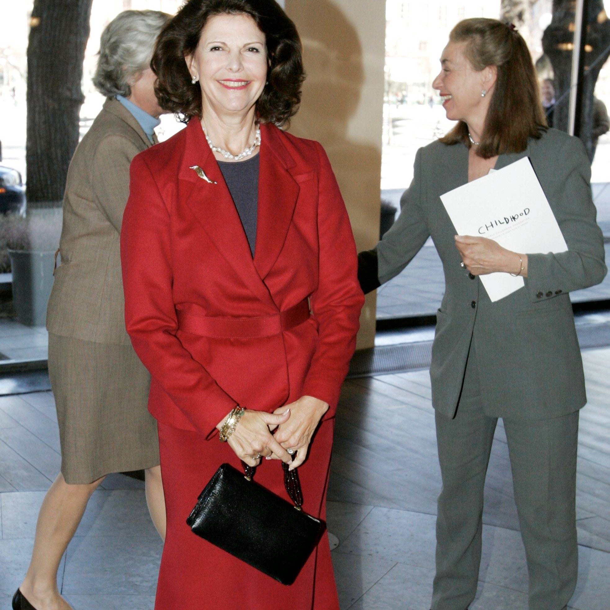 Queen Silvia of Sweden in Stockholm at the World Childhood Foundation, April 18, 2005. Carrying a Darby Scott Iconic Handbag