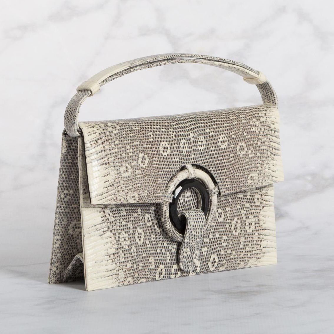 Ad in NYT Ring Lizard Grommet Clutch