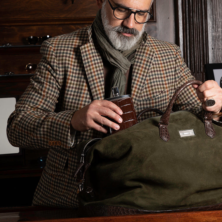 Green Suede Aspen Travel Bag being packed by a man - Darby Scott