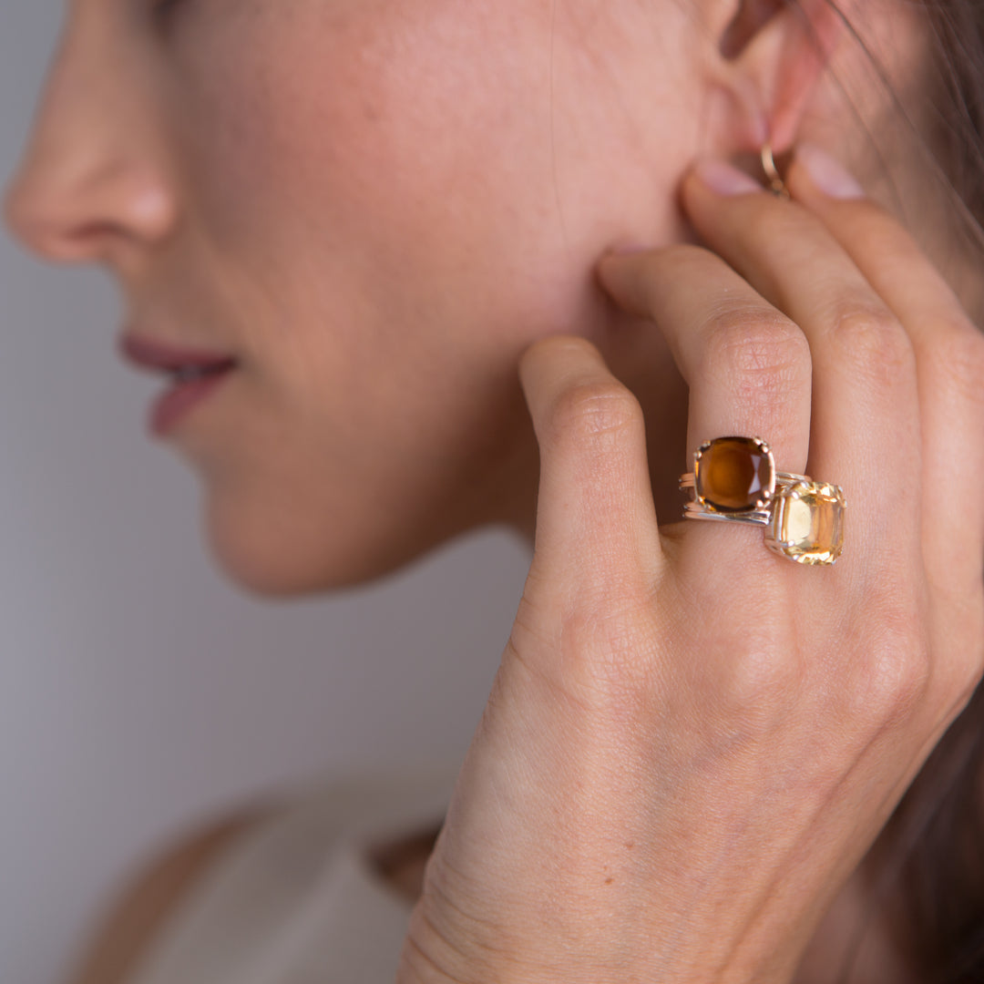 Model wearing imperial topaz and cirine cushion cut rings - Darby Scott