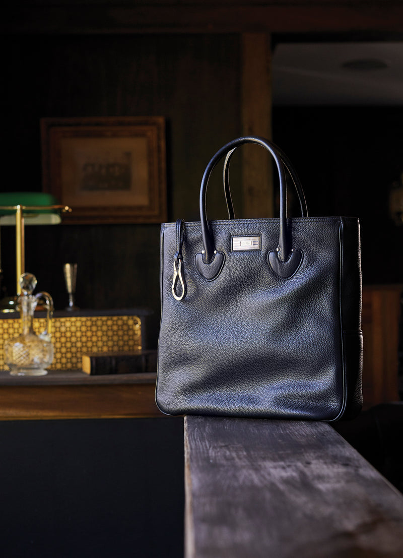 Essex Tote in Black Leather on a bar - Darby Scott
