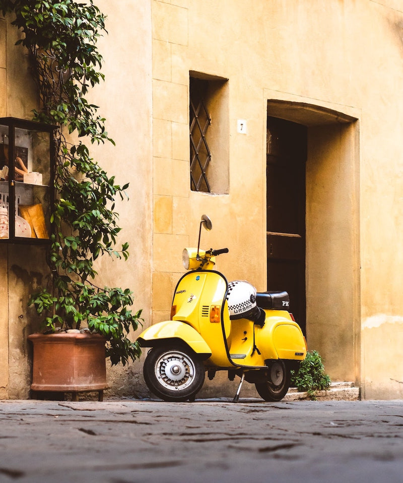 Yellow Scooter parked on street - photo credit Lorenzo Gerosa