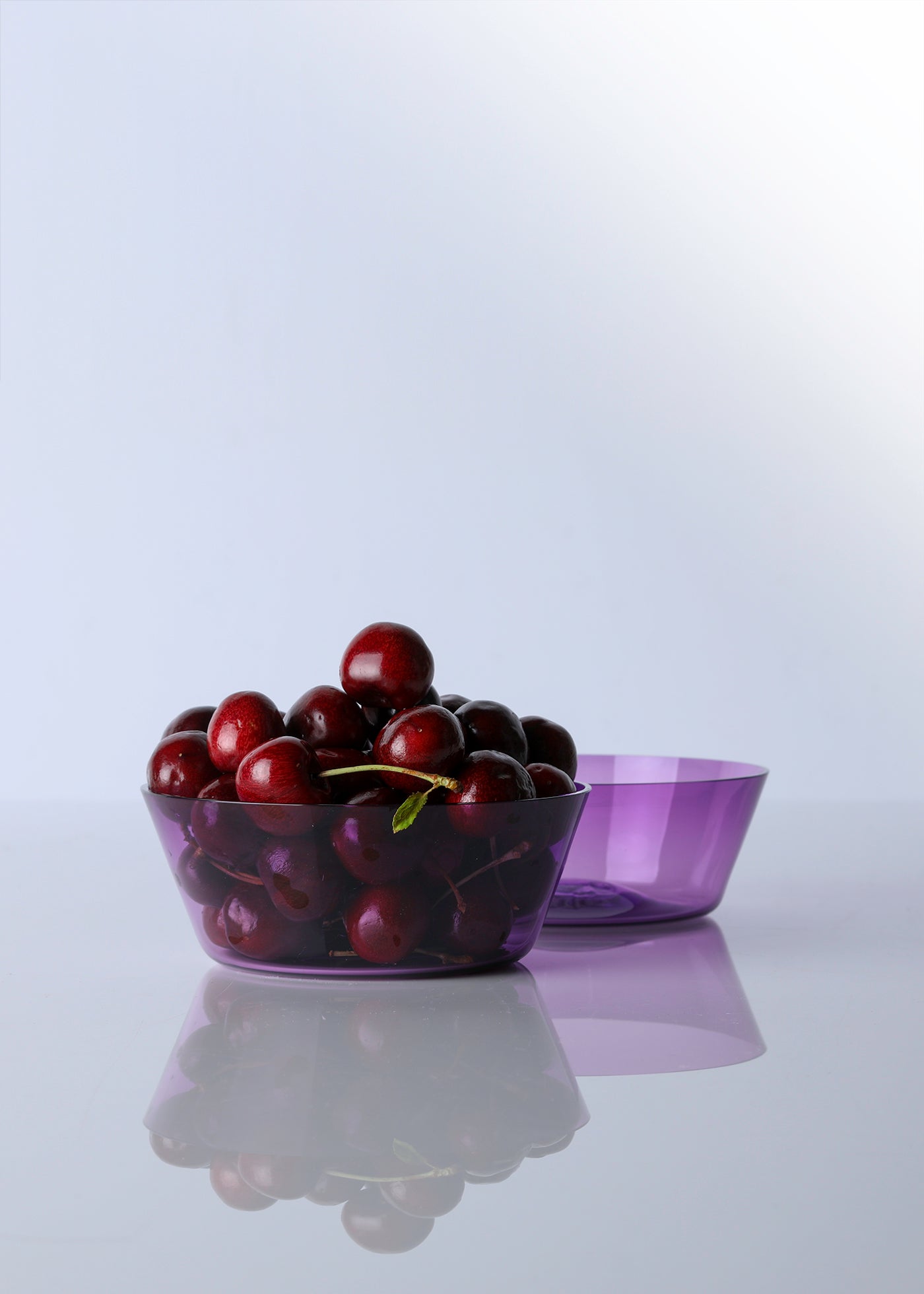 Pair of hand blown amethyst glass bowls with cherries 