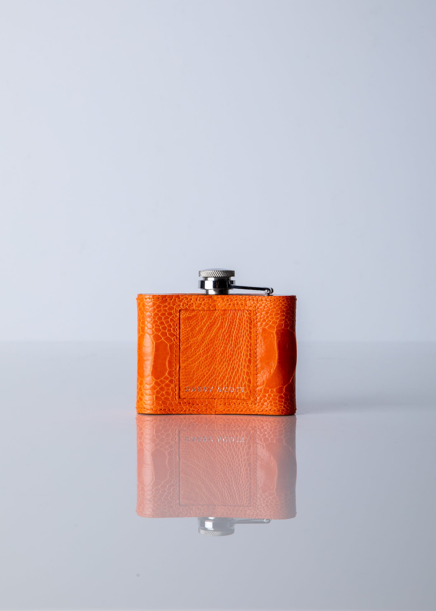 Back of orange ostrich leg covered flask - Darby. Scott 