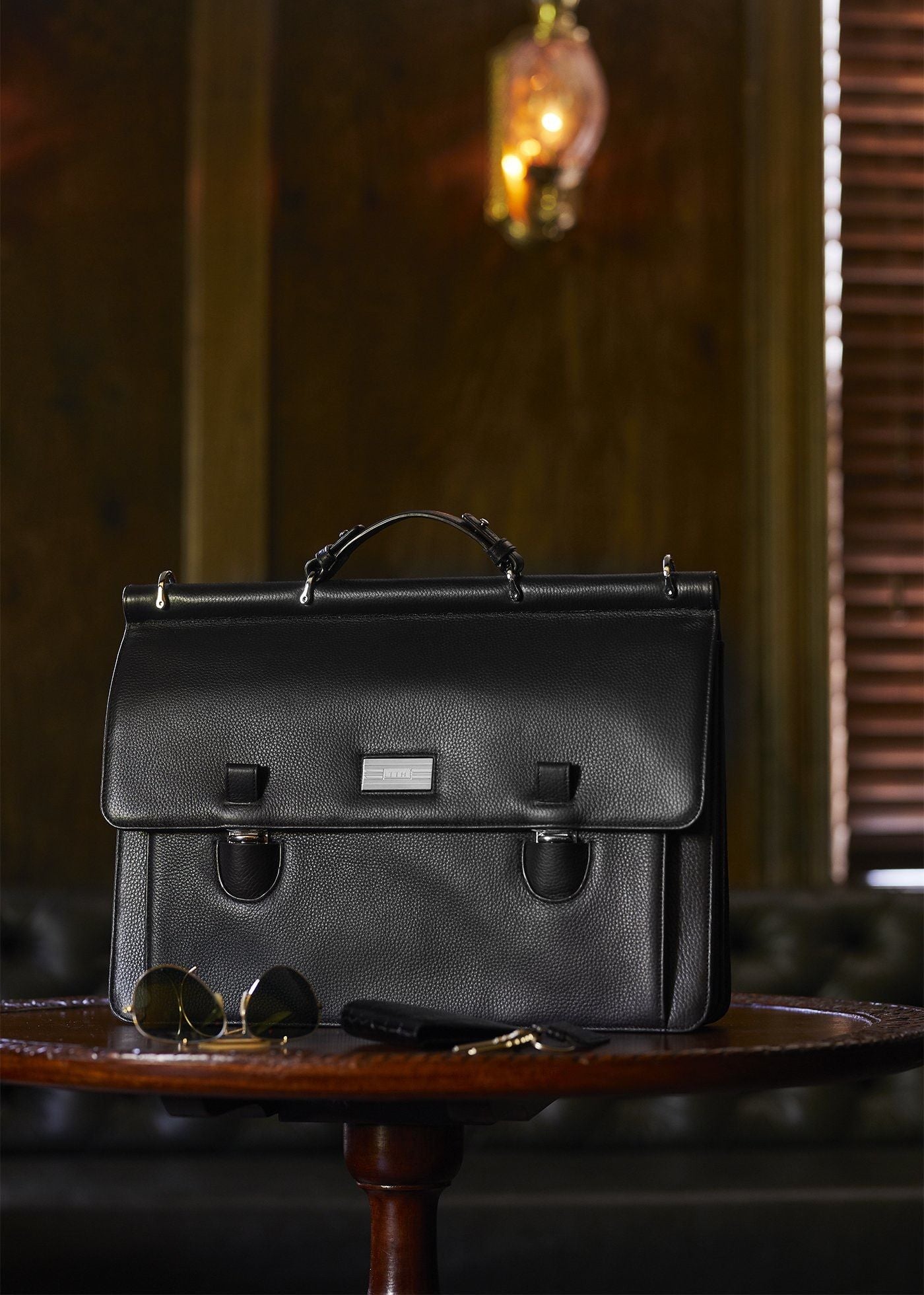 Black leather London Monogram attache on table - Darby Scott