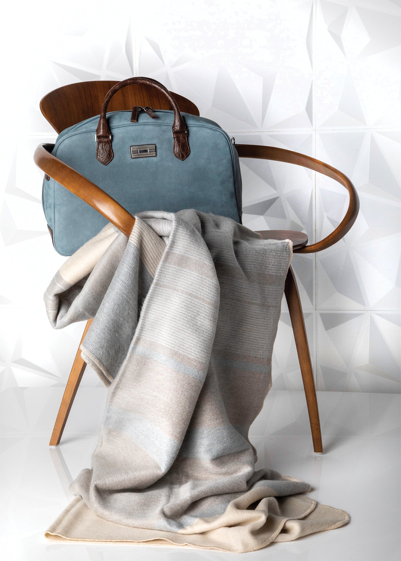 Alpaca throw on chair with blue suede Newport bag  Edit alt text