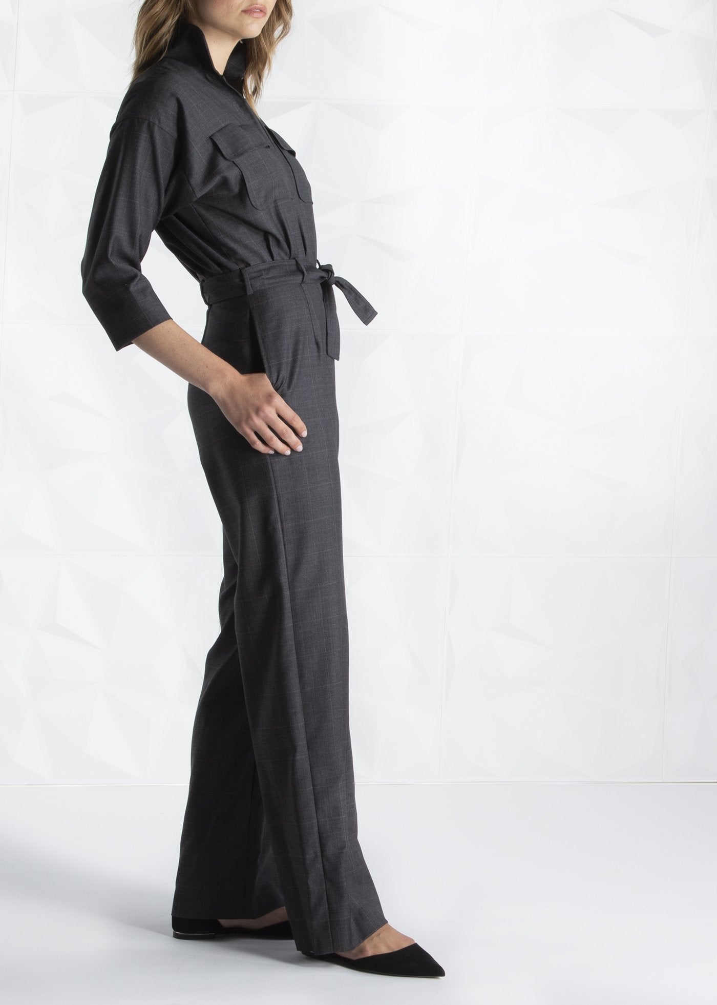 Model in Darby Scott charcoal jumpsuit, side view