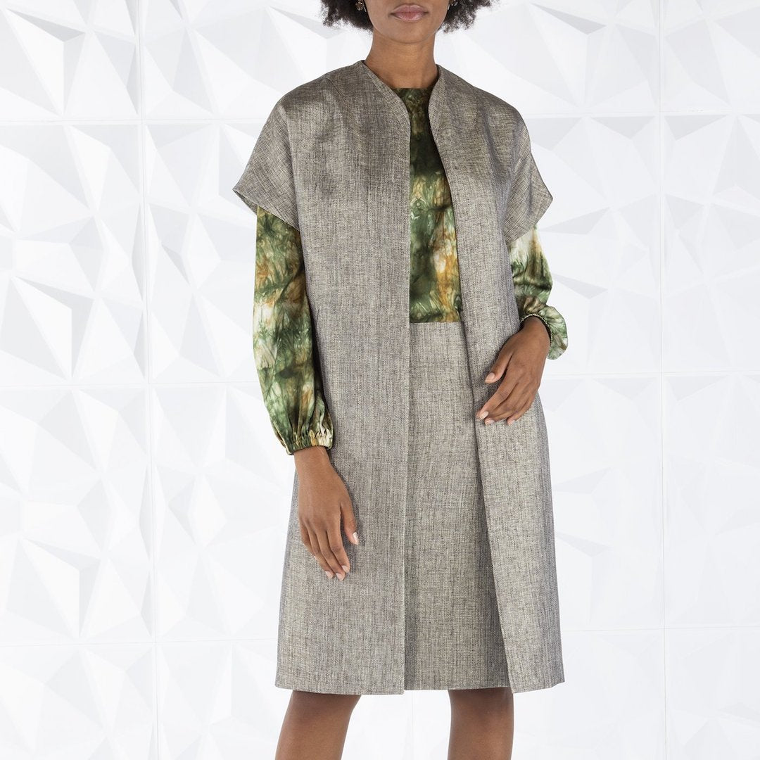Darby Scott model wearing peppercorn tweed topper coat and pencil skirt.