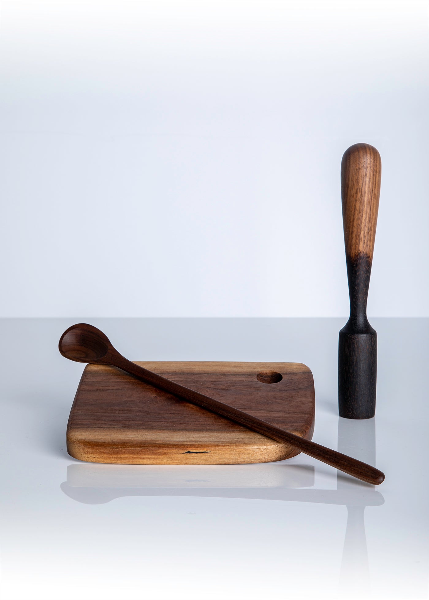 Cutting board with carved long spoon and muddler